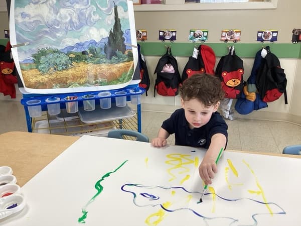 preschooler painting in class