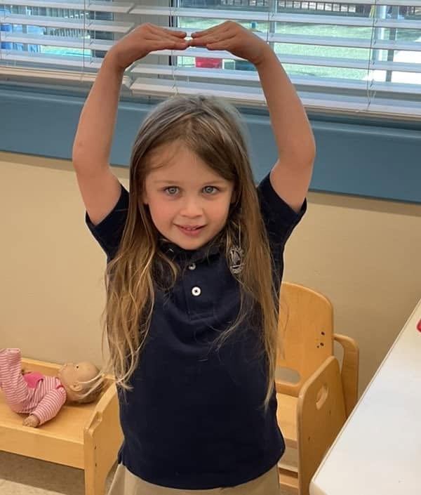 kindergartener practicing ballet arms
