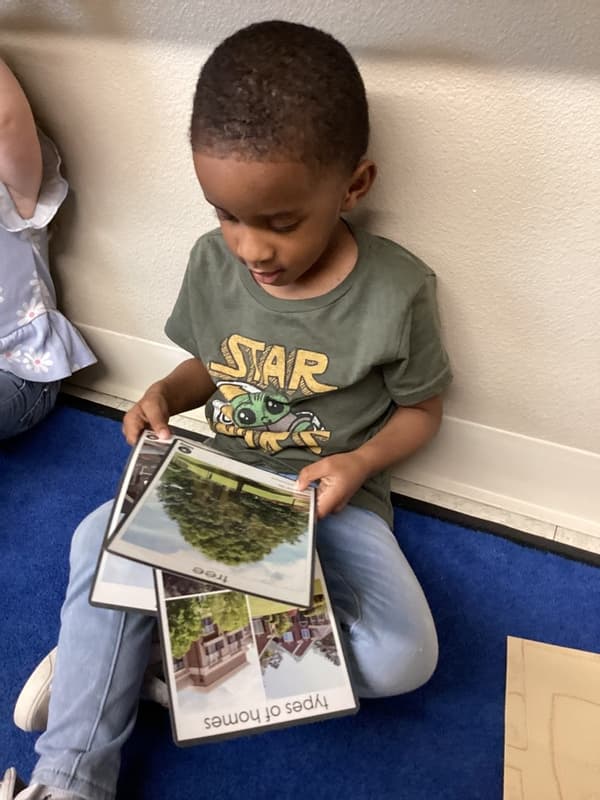 Preschool child reading picture books during quiet learning time at Fort Worth preschool