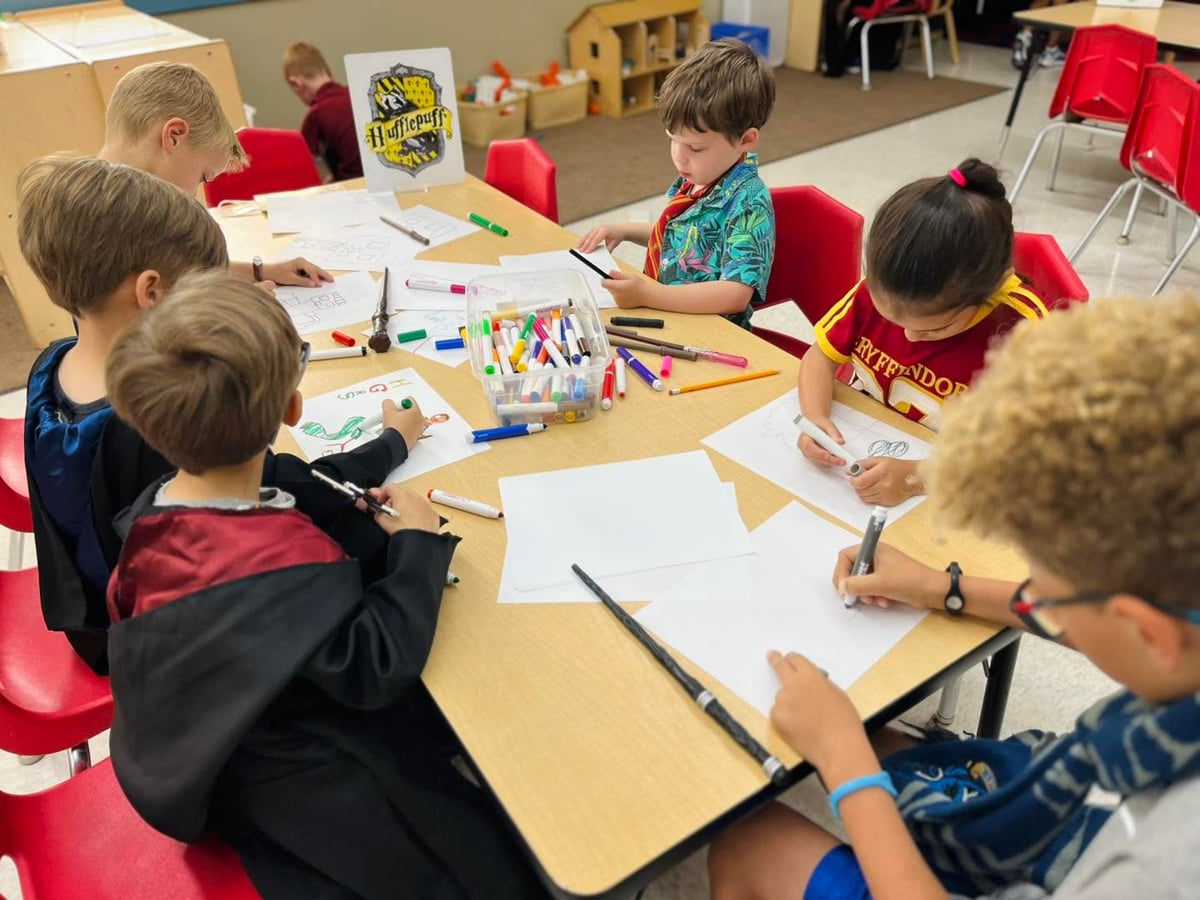 Students working together on a creative classroom project that encourages collaboration, imagination, and problem-solving during a themed learning activity at Primrose School.