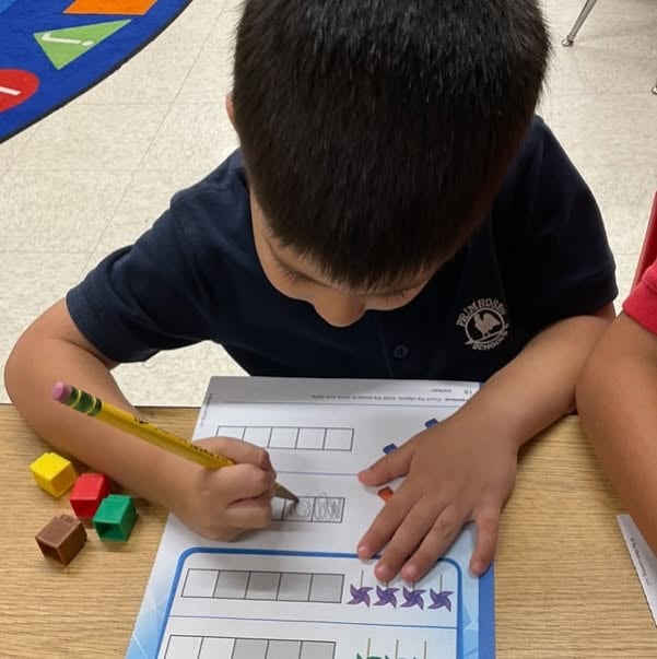 kindergartener practicing math skills