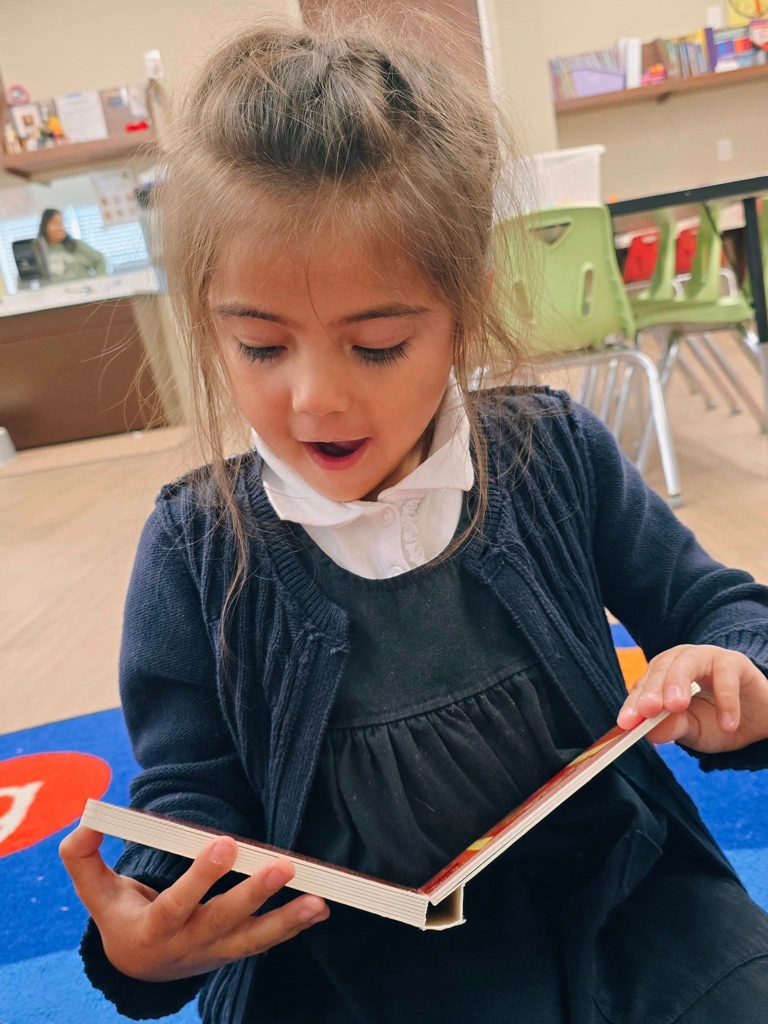 Pre-Kindergarten students exploring books about food from different cultures at a preschool in Keller, Texas 76244.