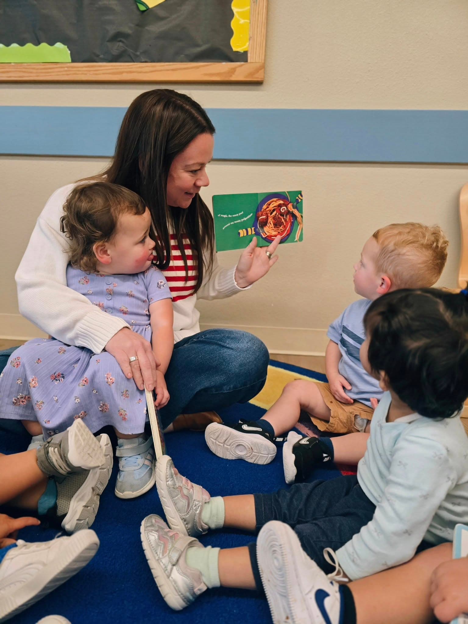 Toddler children being read to about multicultural cuisines at a preschool in Keller, Texas.