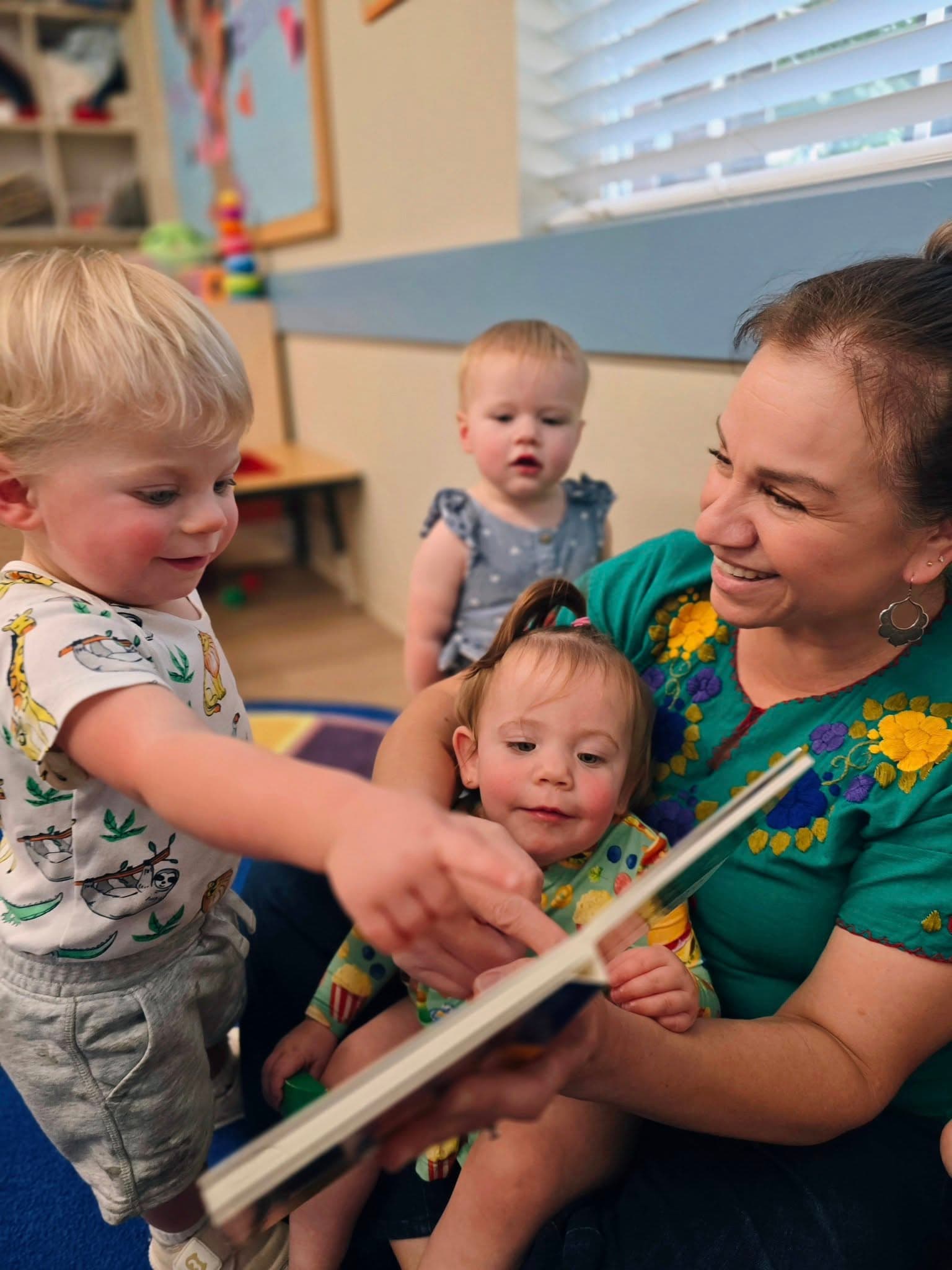 Toddler children being read to about multicultural cuisines at a preschool in Keller, Texas.