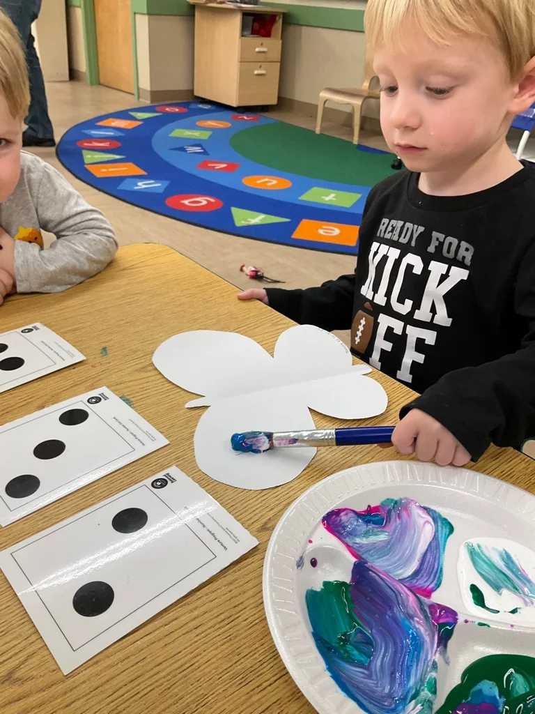 child painting a butterfly