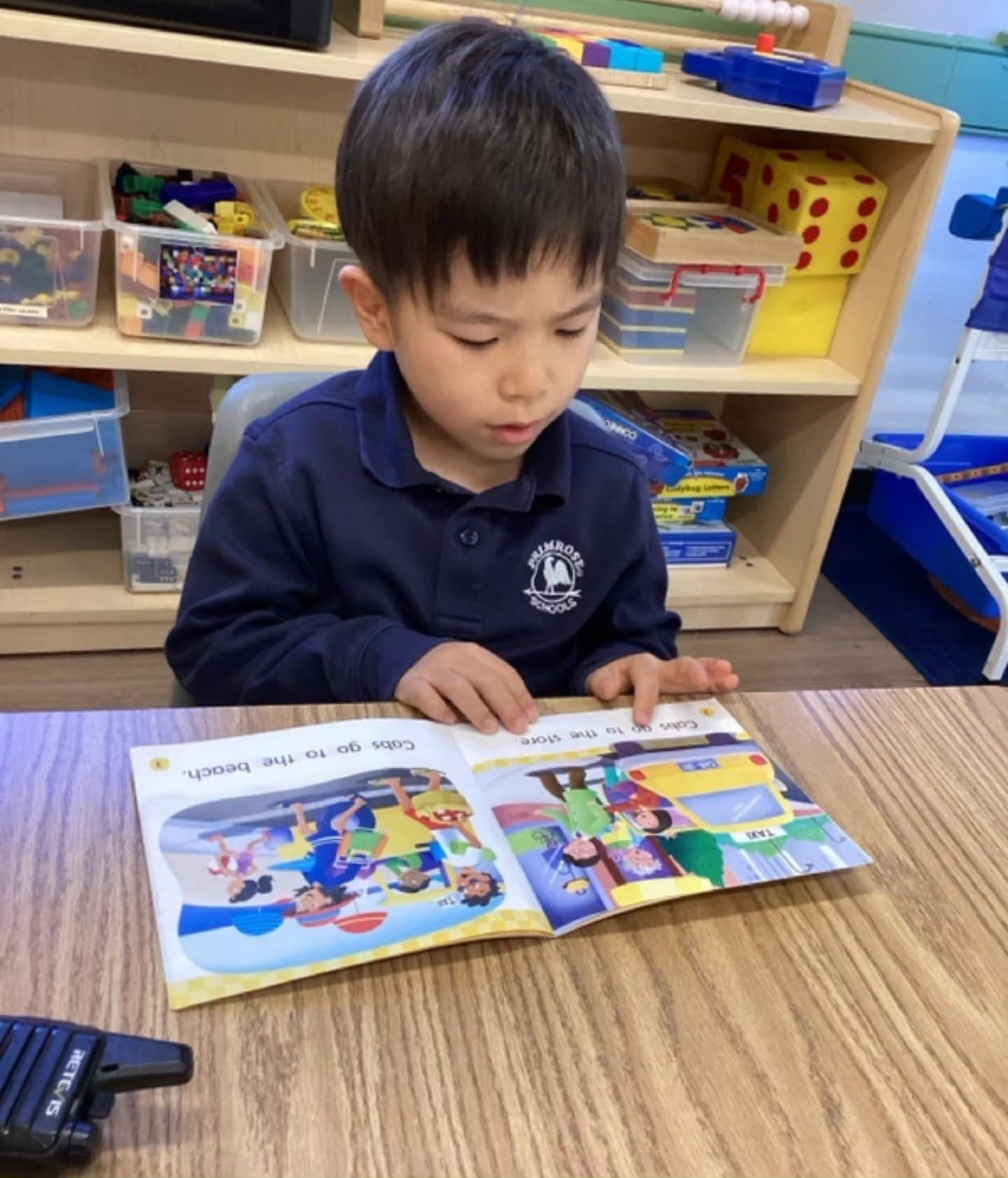 A boy in a primrose uniform reading a book