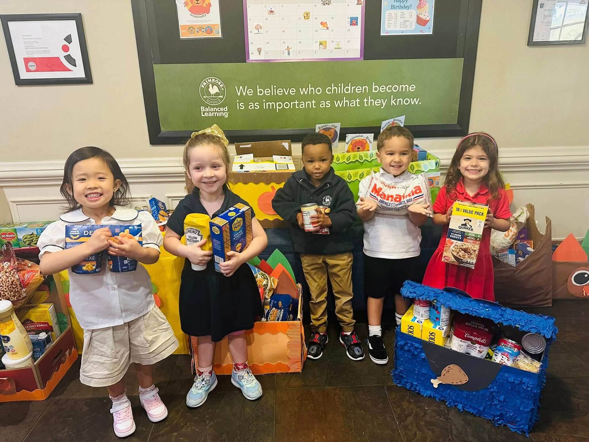 children holding food containers in front of boxes
