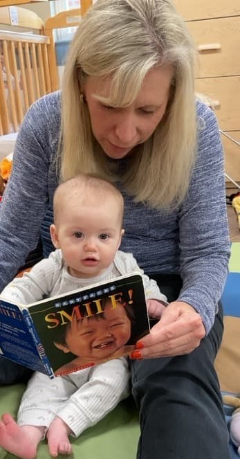 teacher reading to an infant