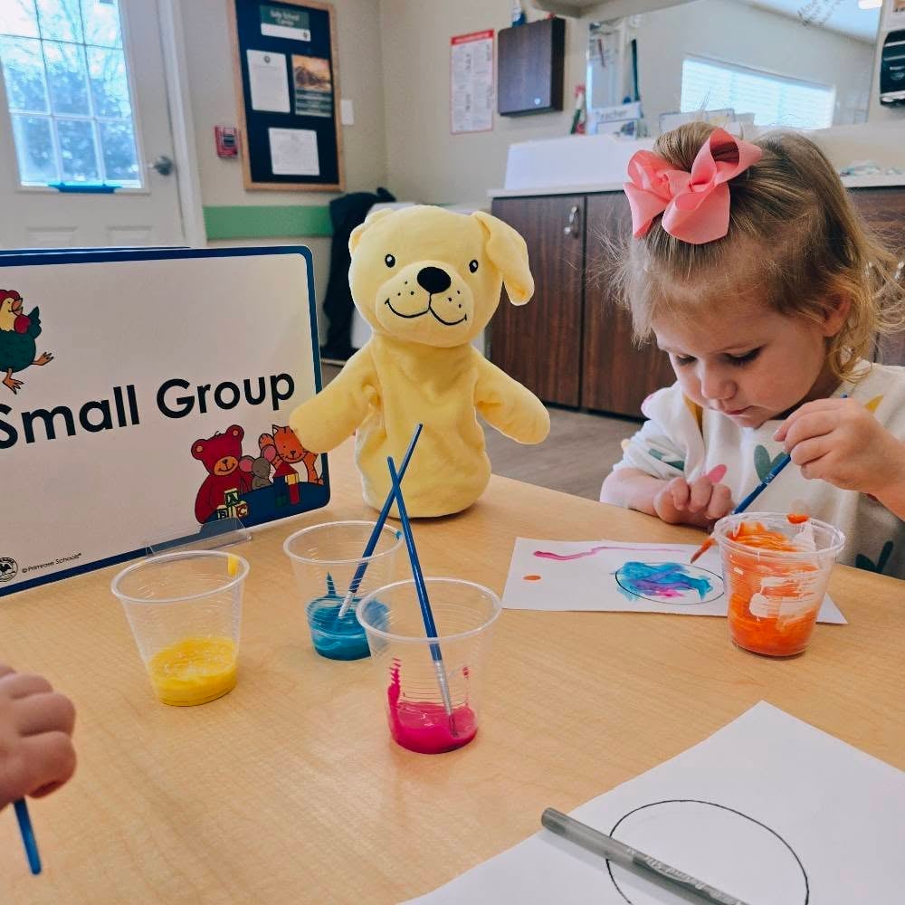 Child engaged in a small group art project, exploring materials and developing creativity during an early learning activity at Primrose Heritage in Keller, TX.