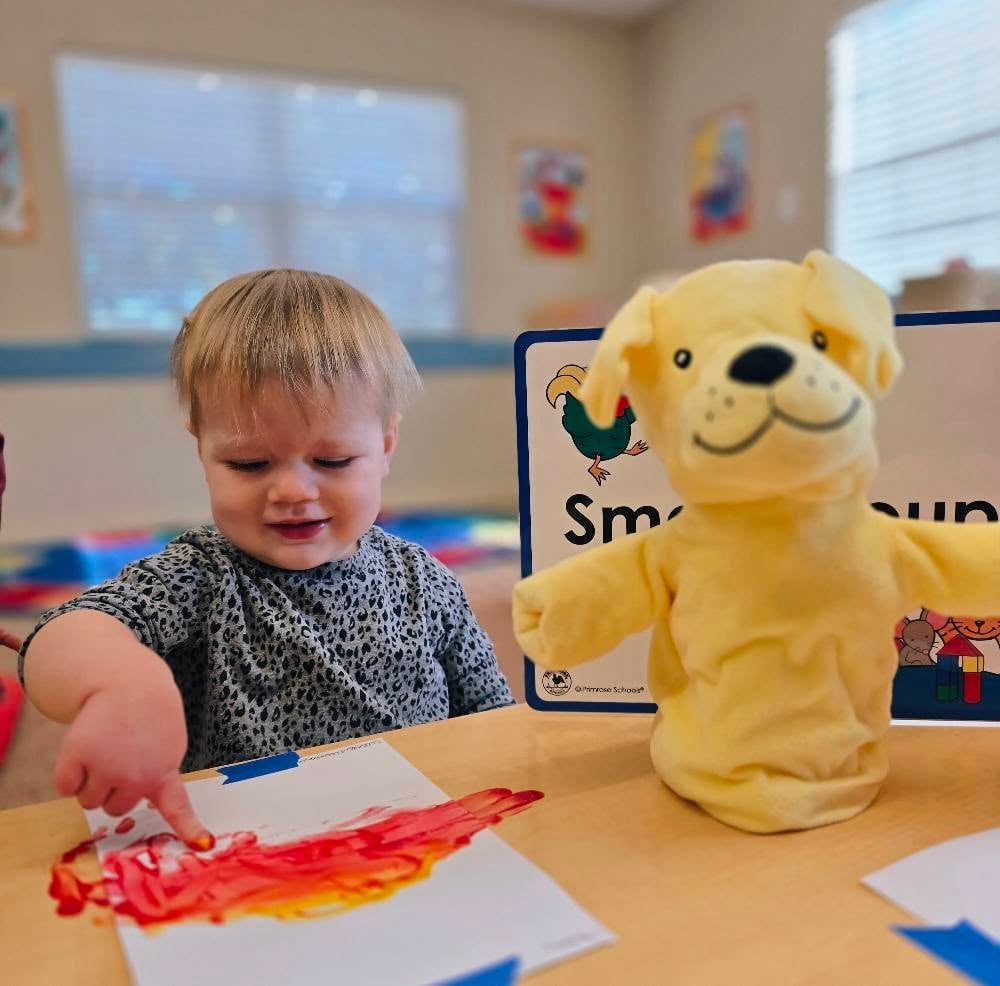 Child engaged in a small group art project, exploring materials and developing creativity during an early learning activity at Primrose Heritage in Keller, TX.