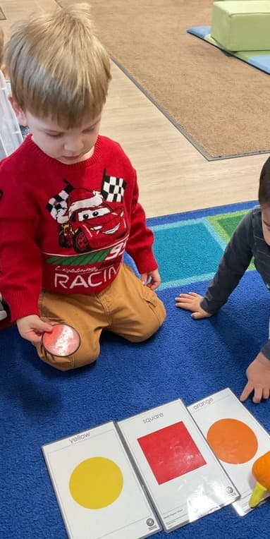 boy matching shapes