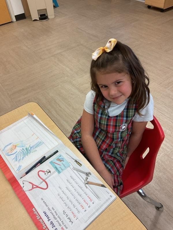 Kindergarten student completes a handwriting and literacy activity while practicing letter formation and fine motor skills at Primrose School.