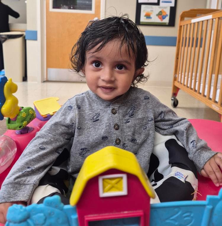 Infant exploring educational toys during playtime at Primrose School, encouraging sensory development and early learning