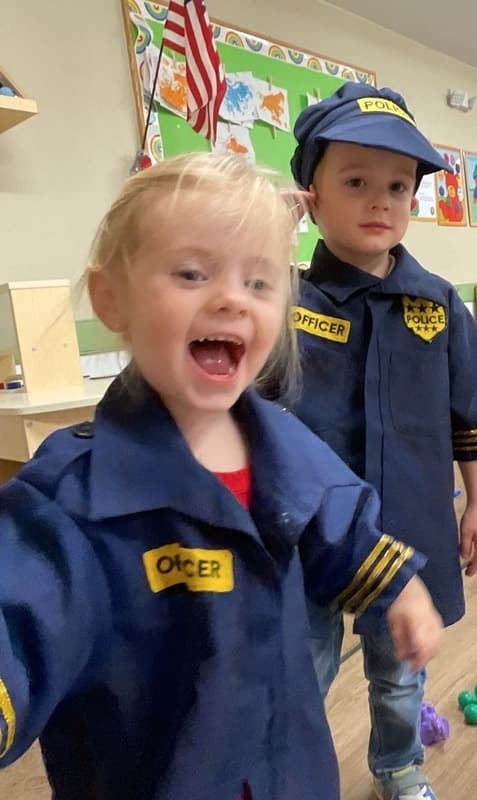 A girl and a boy dressed up as police officers