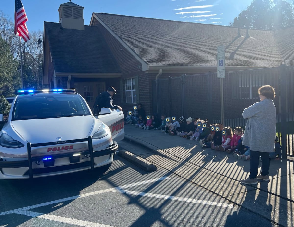 Primrose School students learning about community safety with a local police officer on National Law Enforcement Day