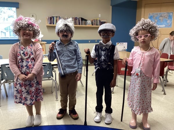 Preschool children dressed as senior citizens during a creative dress-up day that encourages imagination and role-playing.