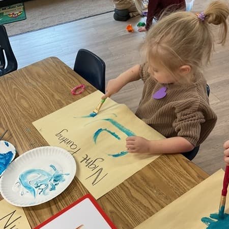 Girl painting a night sky