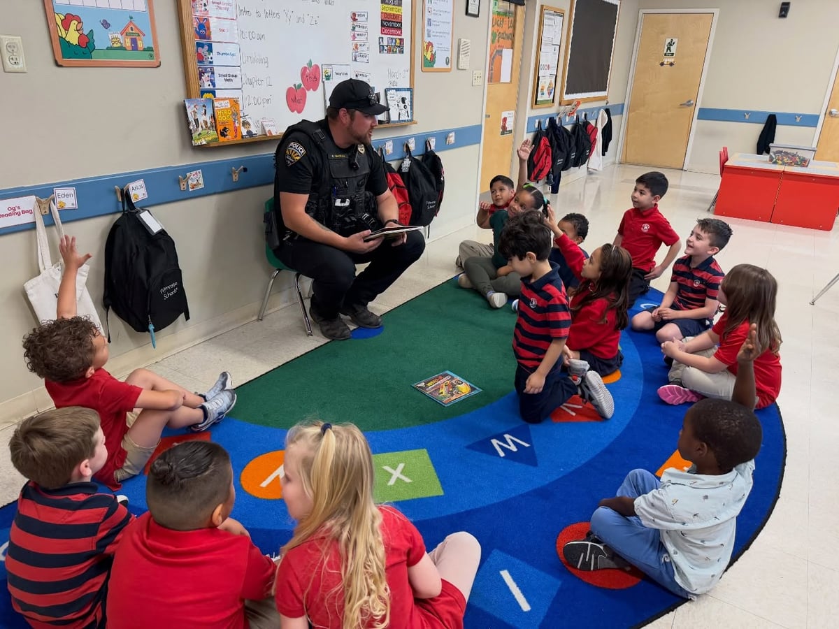 police officers reading to pre-k students