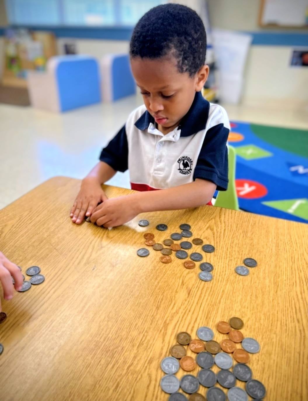 Student sorting and counting coins during a hands-on math lesson focused on money recognition and financial literacy concepts.