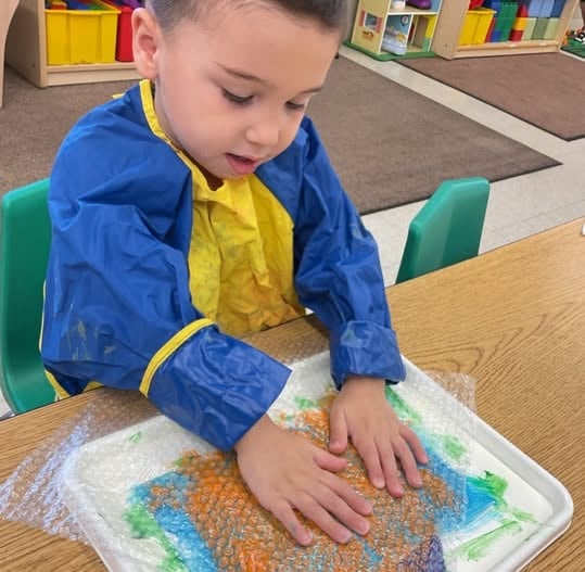 preschooler feeling textures through art