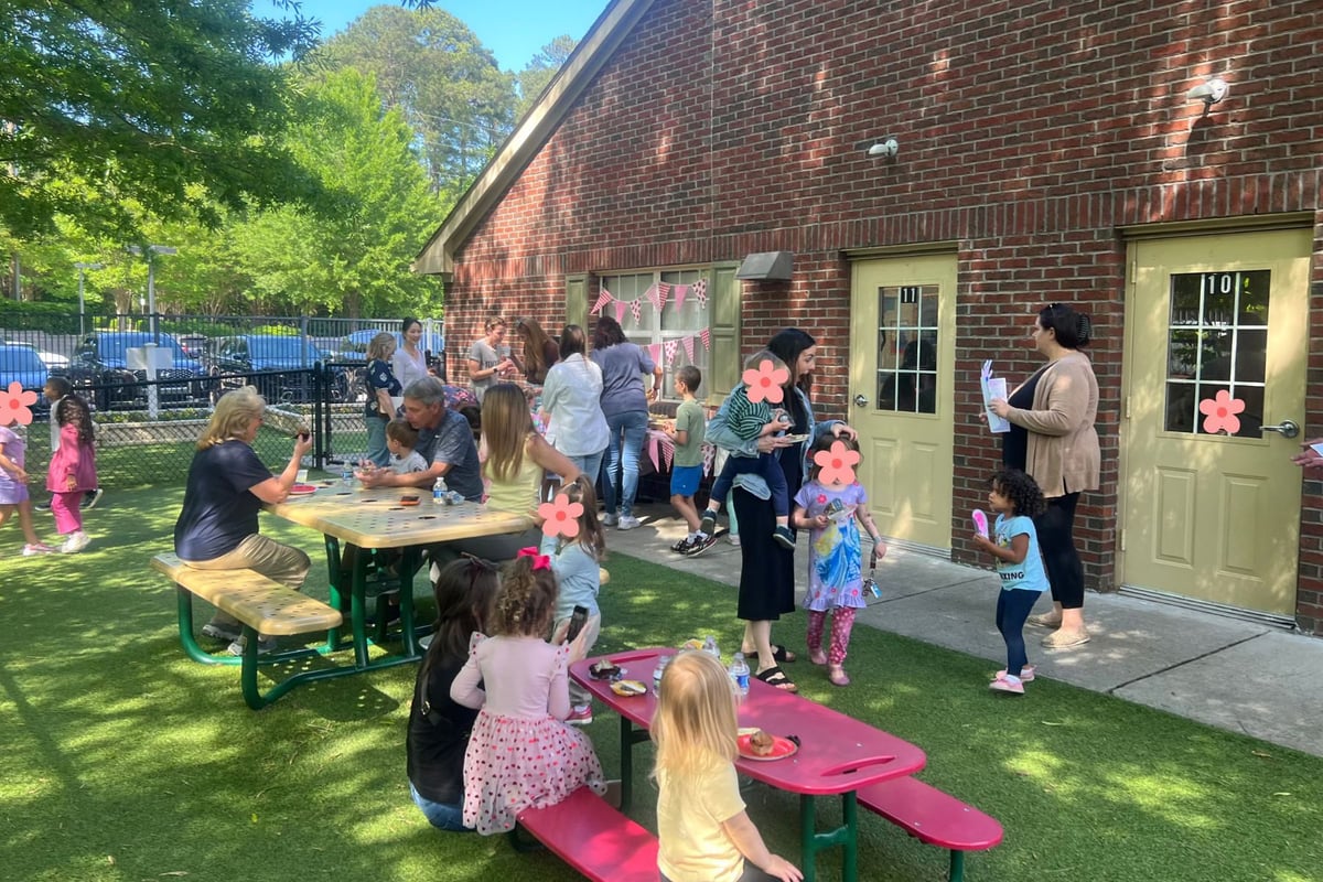 Mothers enjoying snacks and refreshments during a Mother’s Day celebration at Primrose Schools