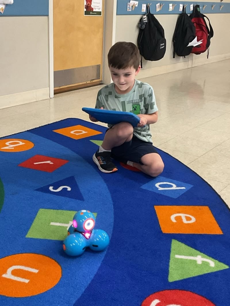 student controlling small robot