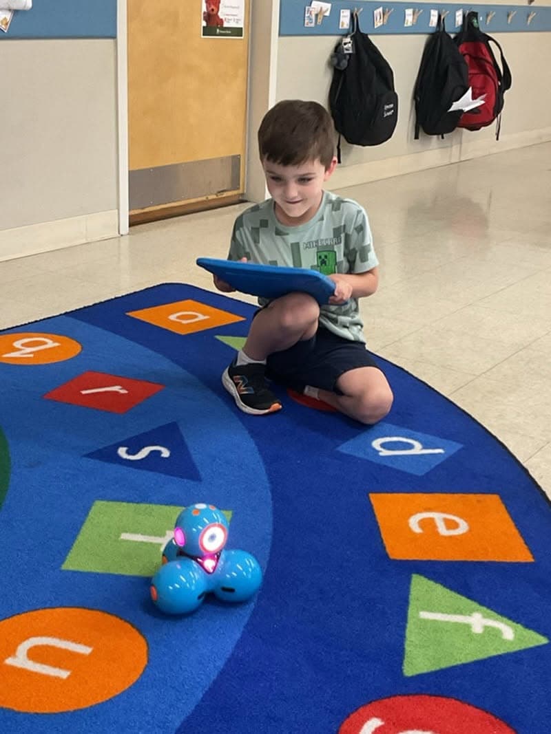 student controlling small robot