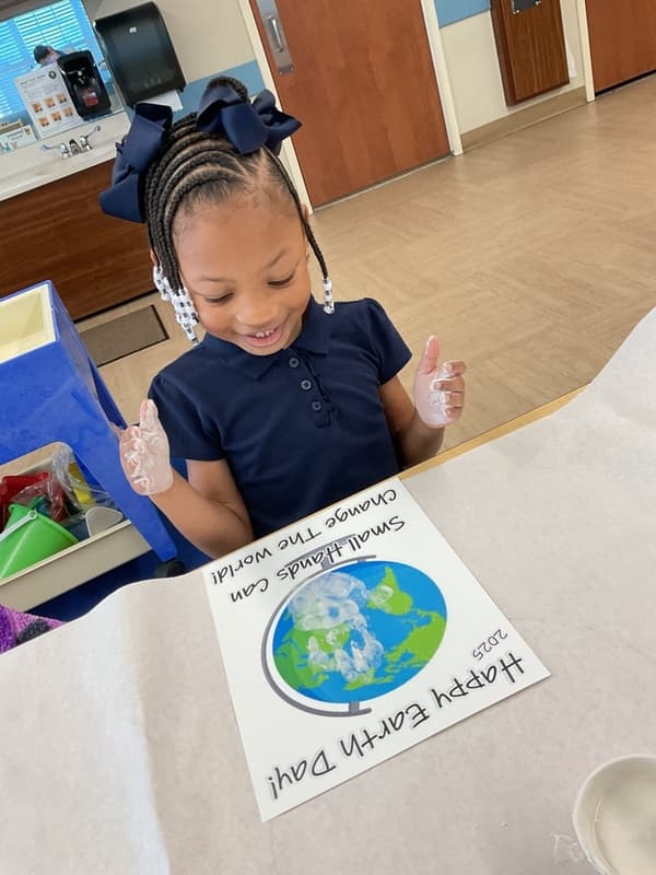 Girl painting an Earth for Earth Day.