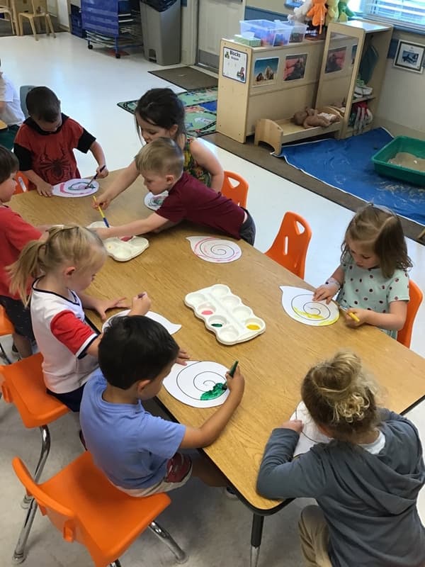 children painting a seashells
