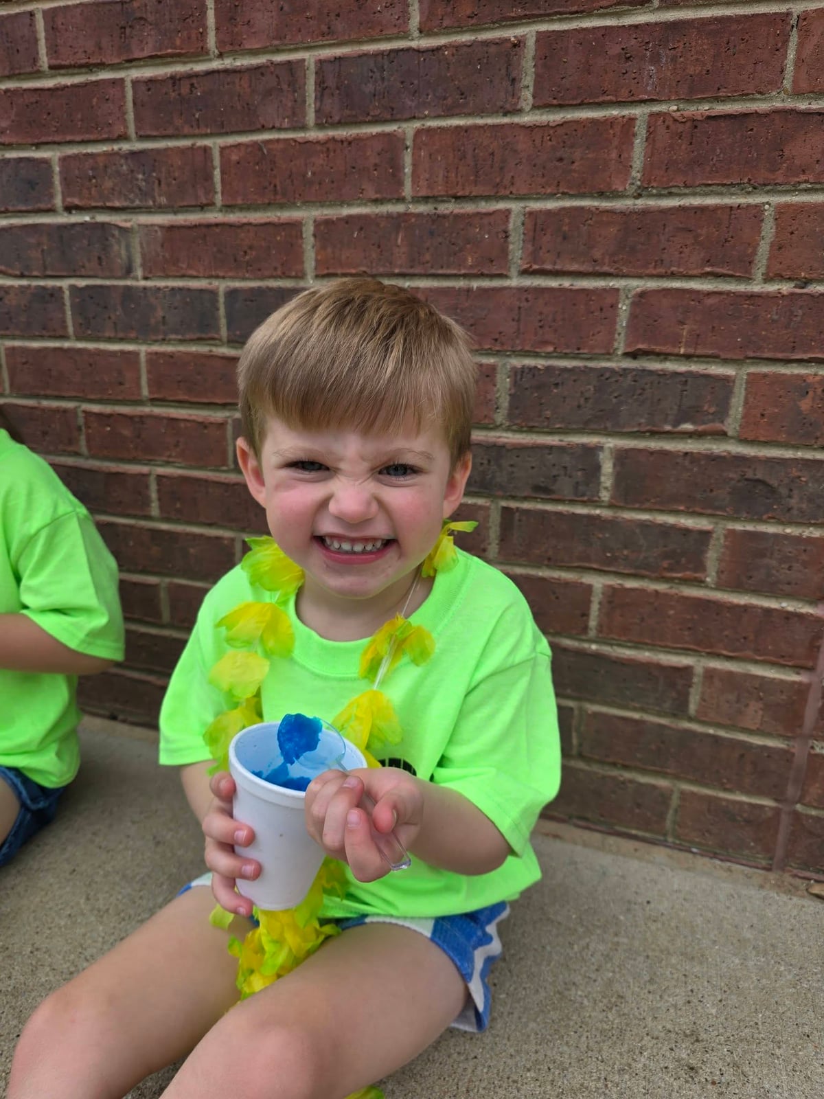 A pre-k student enjoying a snow cone at Primrose School at Heritage.