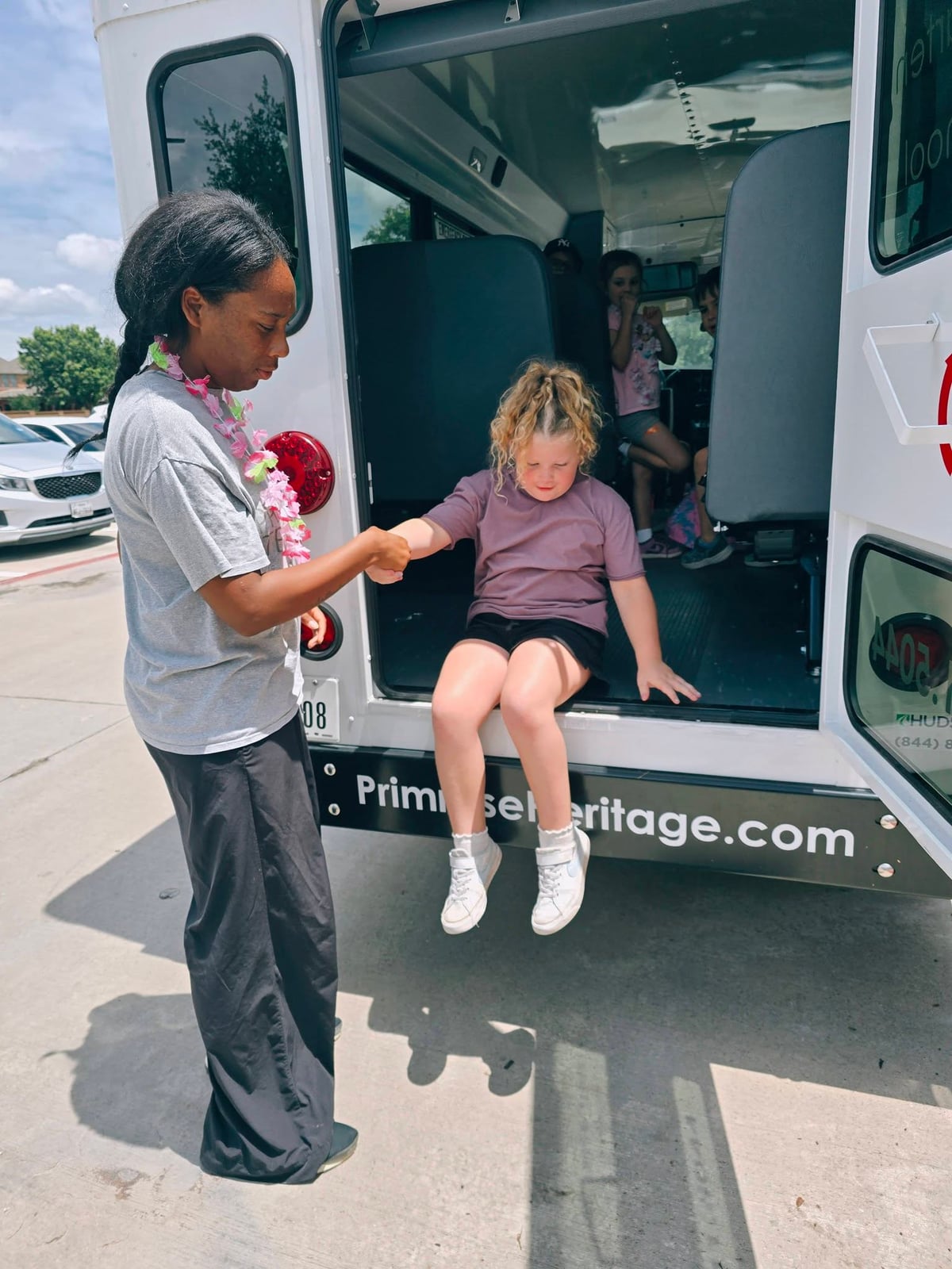 A Summer Adventure Club student participating in a bus evacuation drill with Primrose School at Heritage.