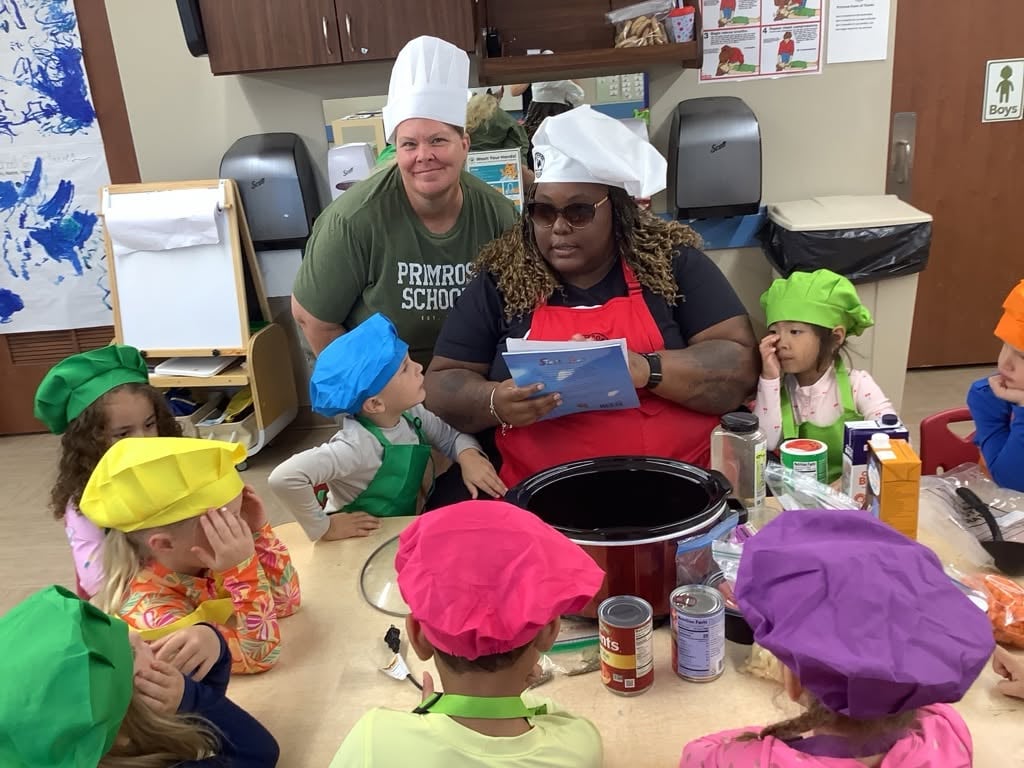 Children at a table making stone soup