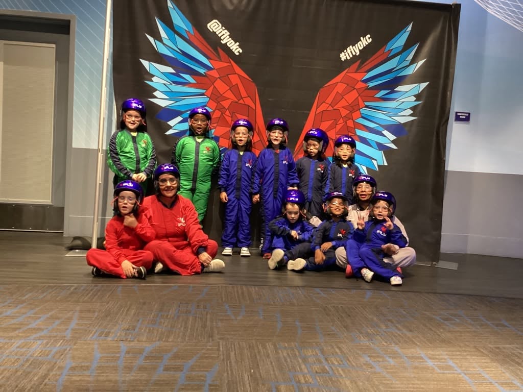 Children standing in front of wings