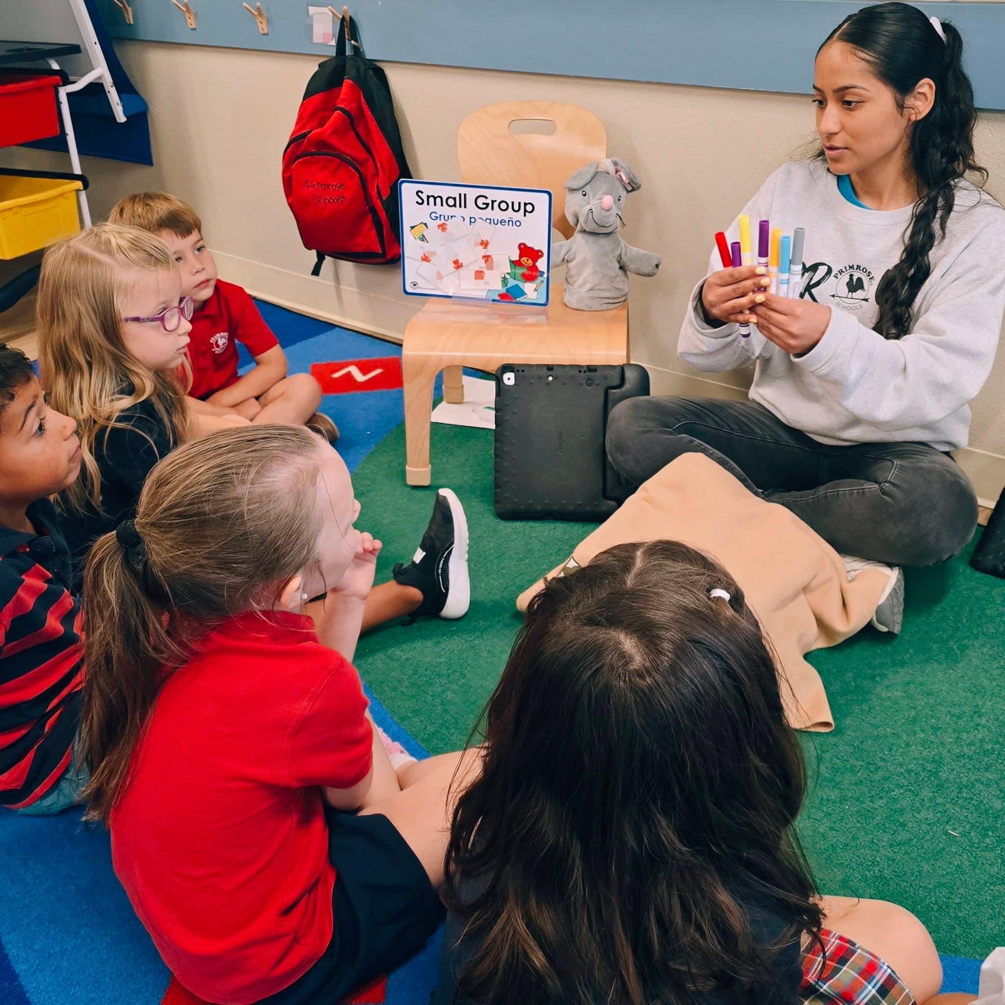 A Pre-K teacher leading her students in a small group lesson at Primrose School at Heritage in Keller, TX.