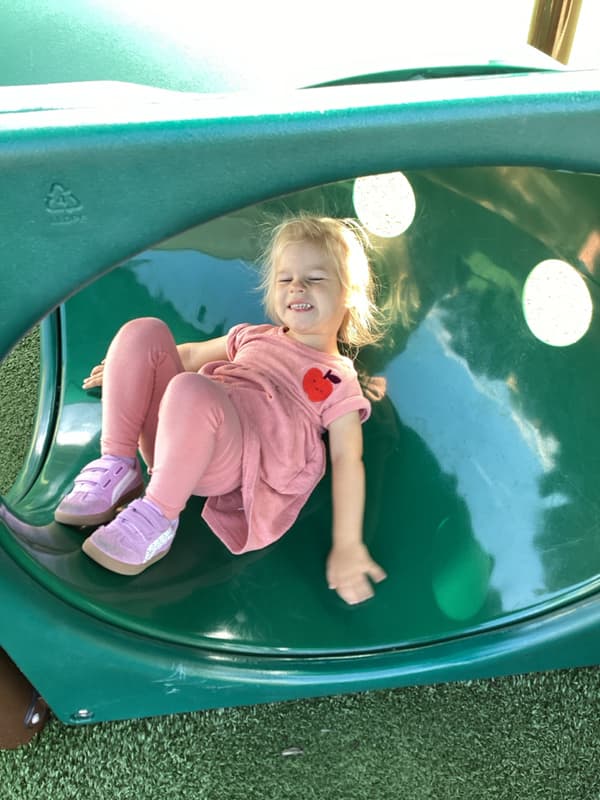 Child sitting in our toddler play tube on playground