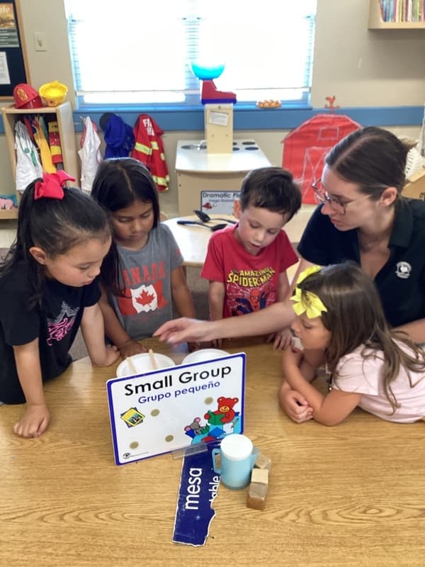 pre-k kindergarten students doing a small group stem activity.
