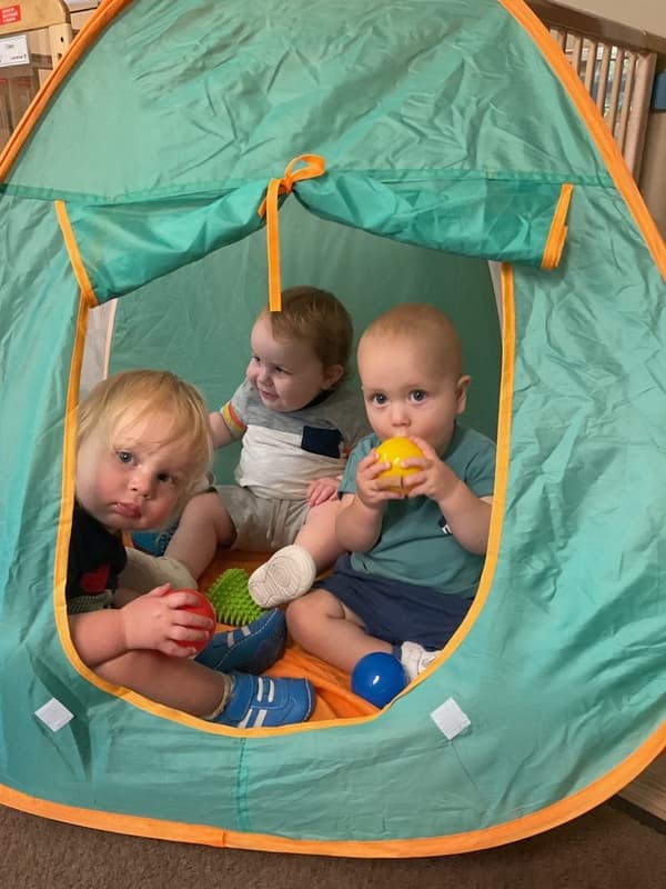Three boys in a tent