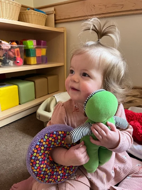 Sweetest little caretaker! This tiny nurturer is showing so much love and gentleness while taking care of her baby doll.