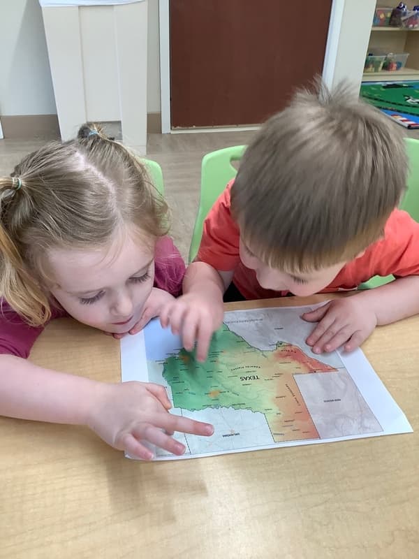 Children learning about a map of Texas during classroom instruction