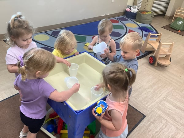 children playing at a water table