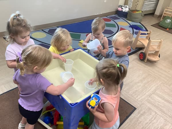 children playing at a water table