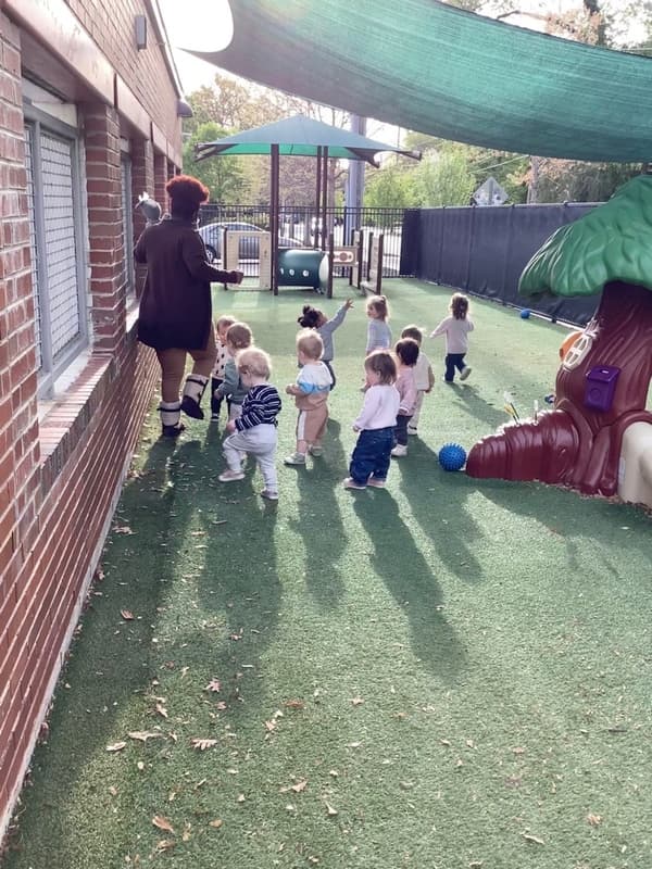 children and a teacher on the playground