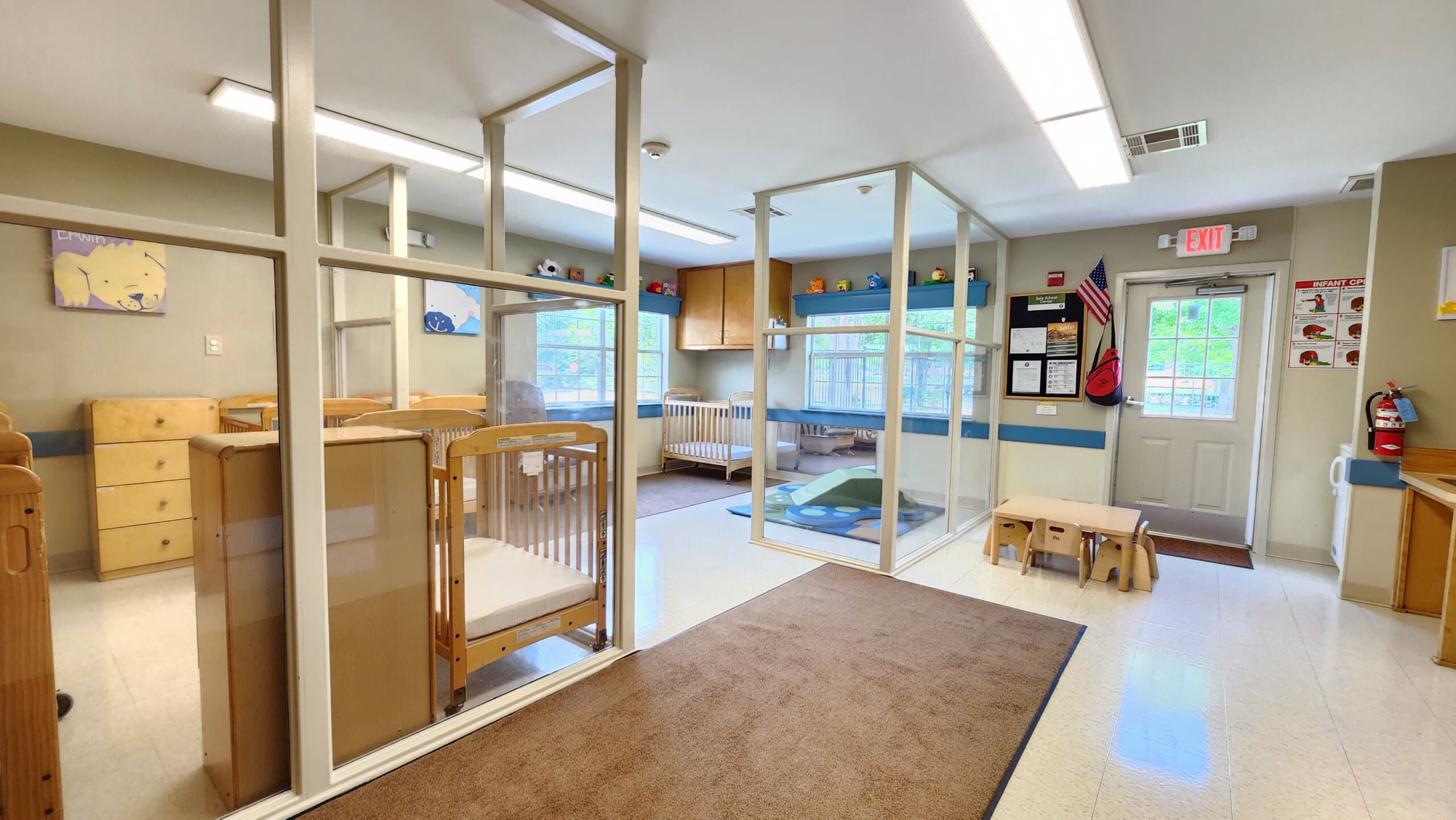 "Older Infants Room with Safe Baby Cribs, Colorful Play Equipment, and Stimulating Early Childhood Development Activities"