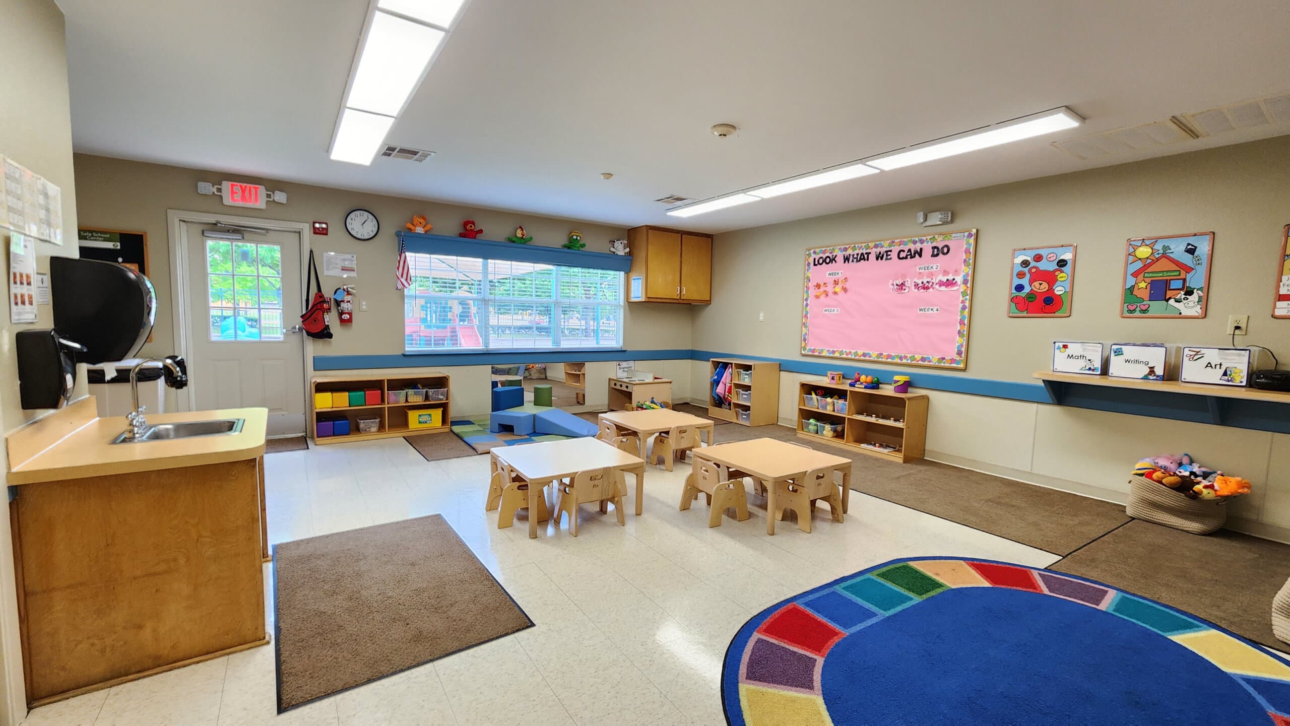 "Young Toddler Classroom, Neatly arranged safe tables and chairs, Colorful Play Equipment, and Stimulating Early Childhood Development Activities"