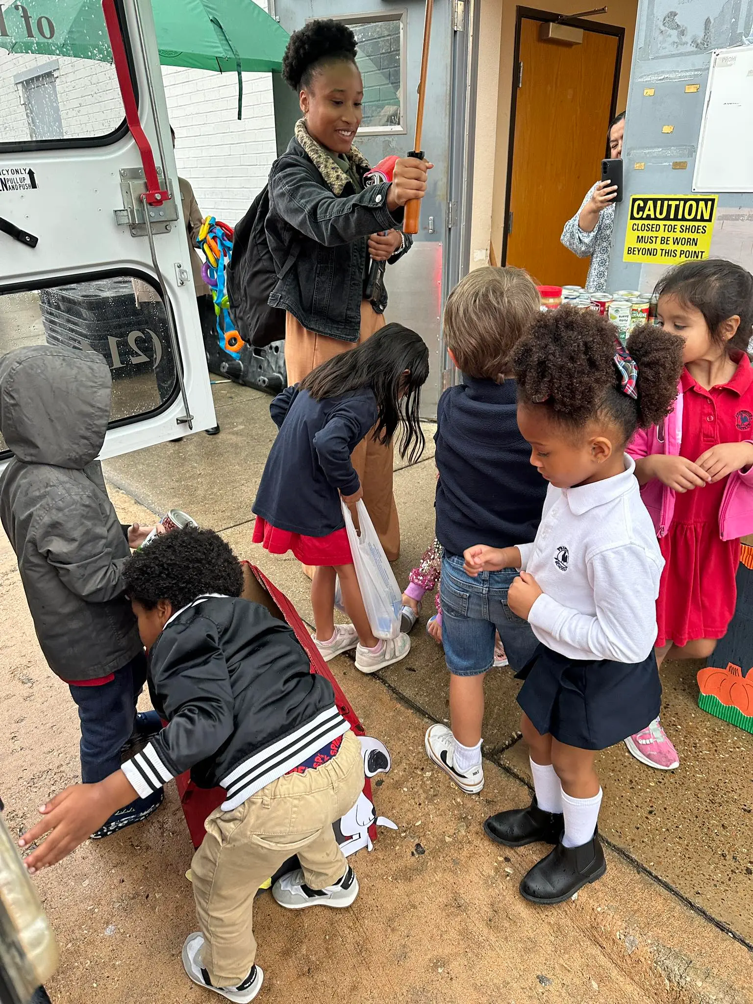 Children donating cans from food drive