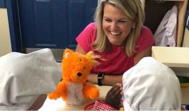 Teacher Heidi engaging Pre-K students with puppet play at Primrose School of Eagan preschool in Eagan, MN