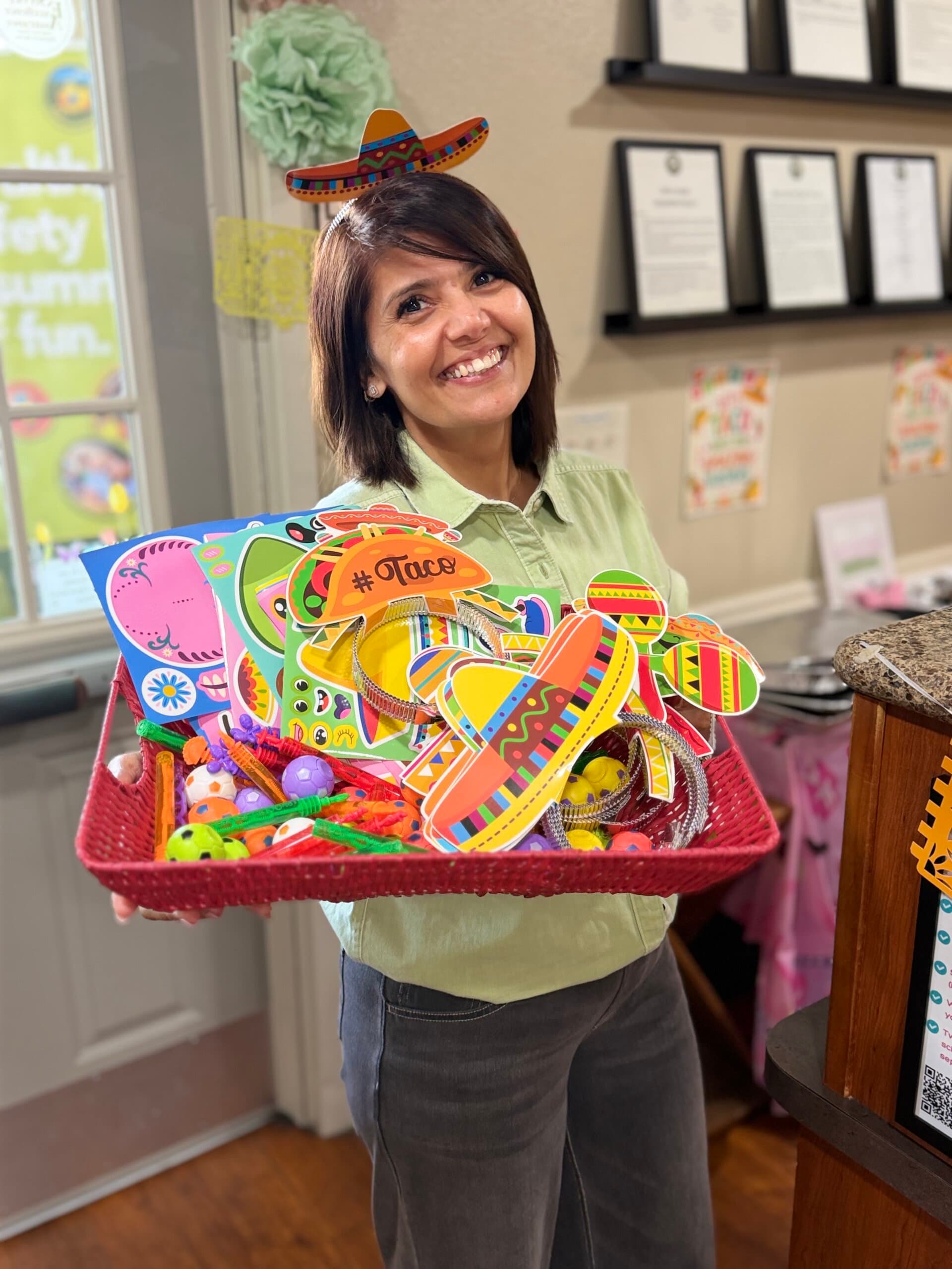 franchise owner holding cinco de mayo goodie for kids on their way out