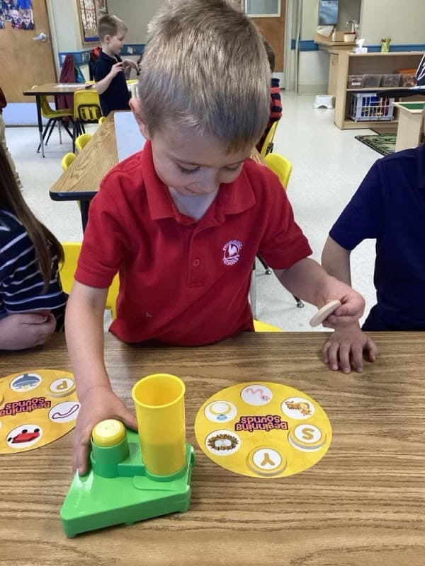 Boy wearing a Primrose uniform participating in the curriculum