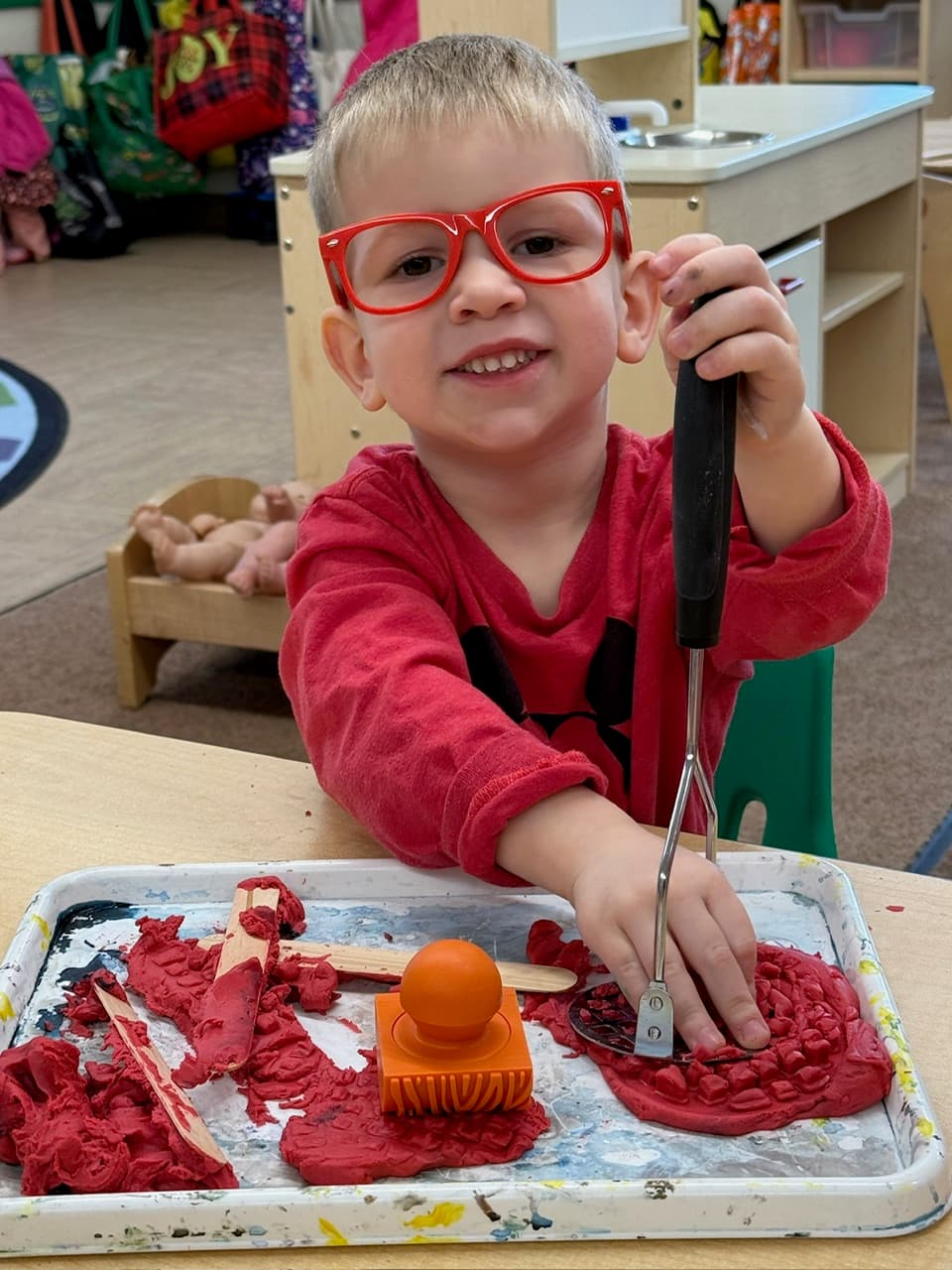 Child playing with modeling dough.