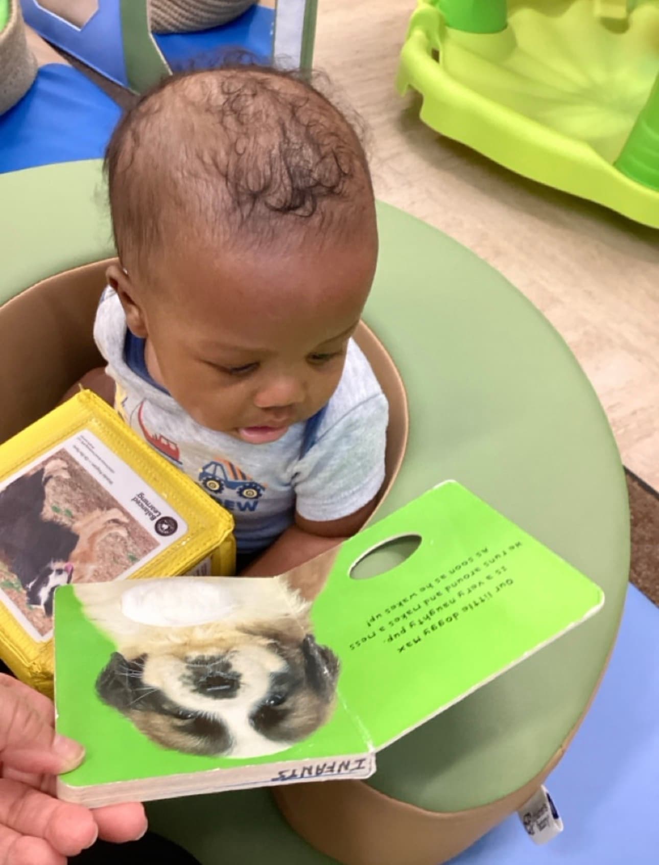 Infant being read to in the classroom at Primrose School at Summerwood